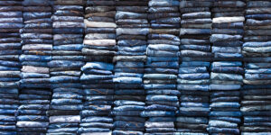 A stack of 100s of jeans folded