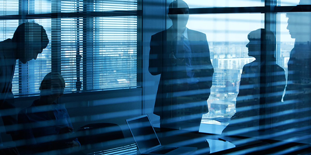 business meeting backlit in a dark office