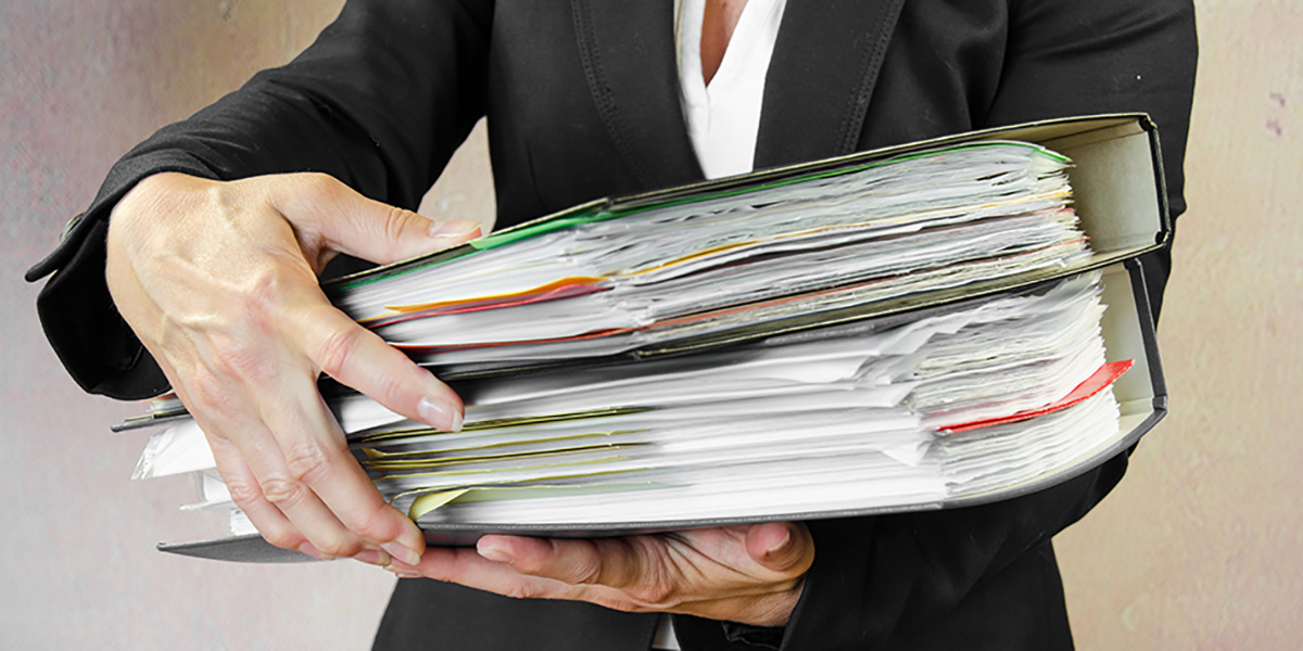 Business woman holding a stack of file folders