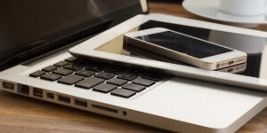 Laptop, tablet, and mobile cell phone devices on desk