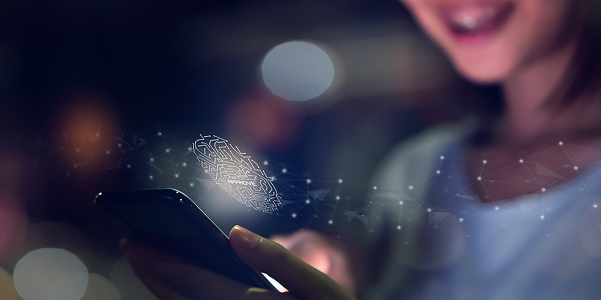 Abstract photo shows a closeup of a woman using the thumb fingerprint biometric data on her mobile cell phone