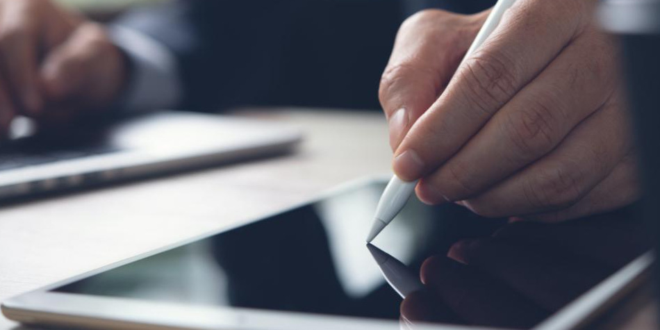 Person writing on tablet with pen