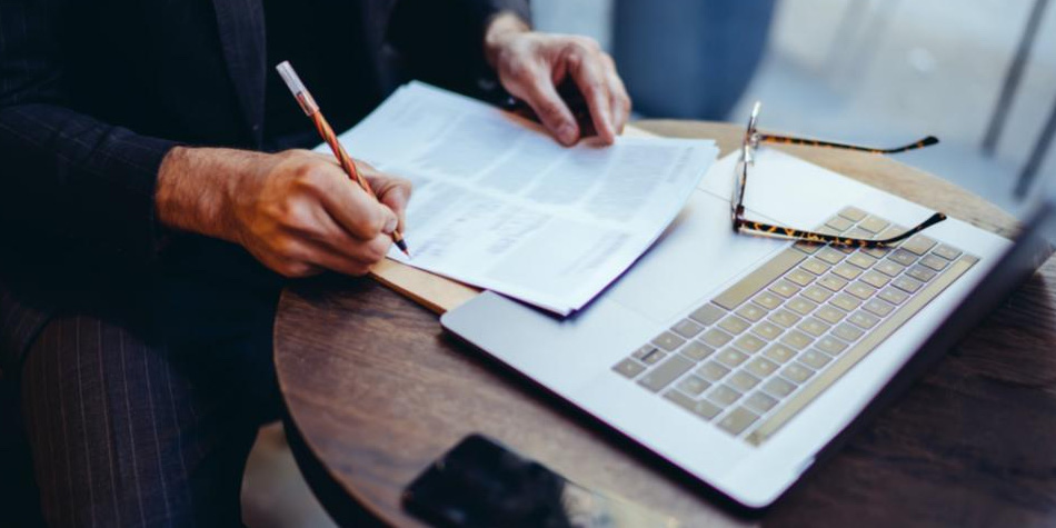 Person with legal documents a phone and a laptop