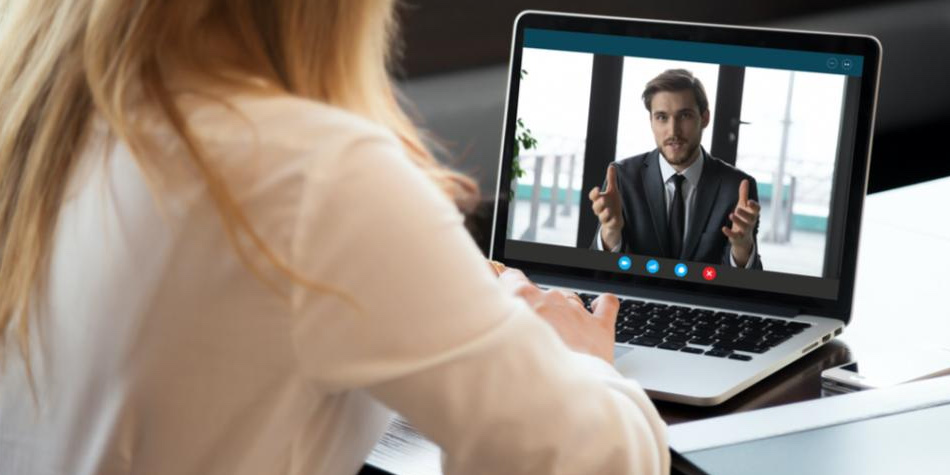 Woman viewing man on laptop