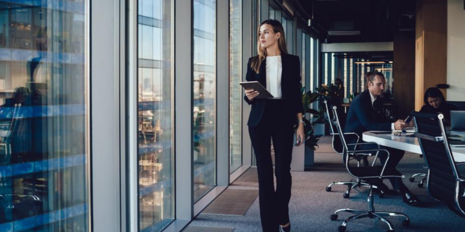 Woman with tablet walking in a conference room