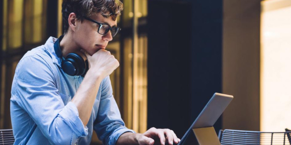 Man with headphones working on tablet