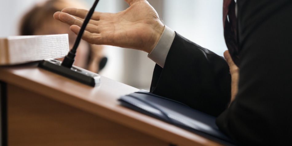 Person standing at a podium with a microphone