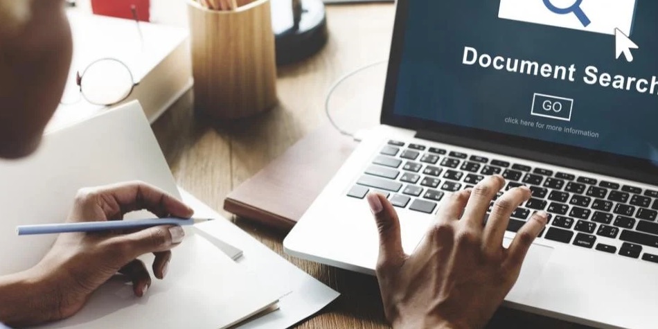 Person working on laptop doing a document search