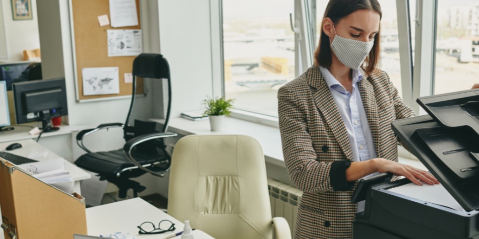 Person in office setting making photocopies